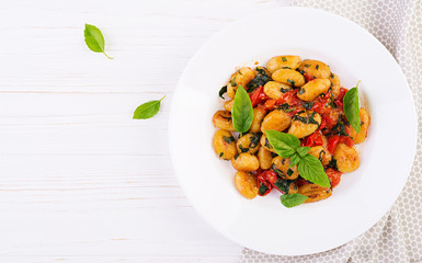 Gnocchi pasta in rustic style.  Italian cuisine. Vegetarian vegetable pasta. Cooking lunch. Gourmet dish. Top view