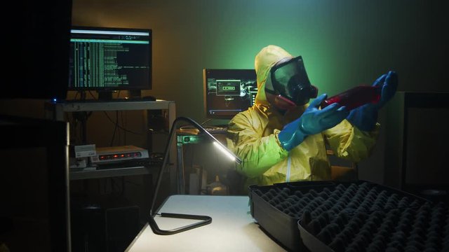 Bioterrorist examines a bottle of dangerous liquid