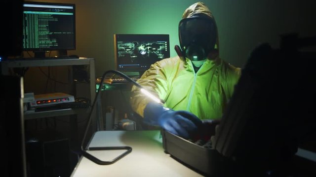 Bioterrorist examines a bottle of dangerous liquid