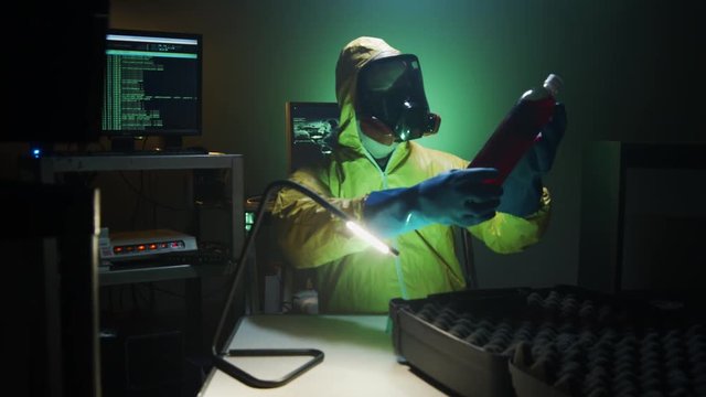 Bioterrorist examines a bottle of dangerous liquid