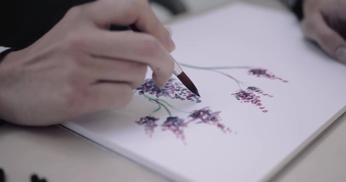 Close-up of artist painting using water colour paint