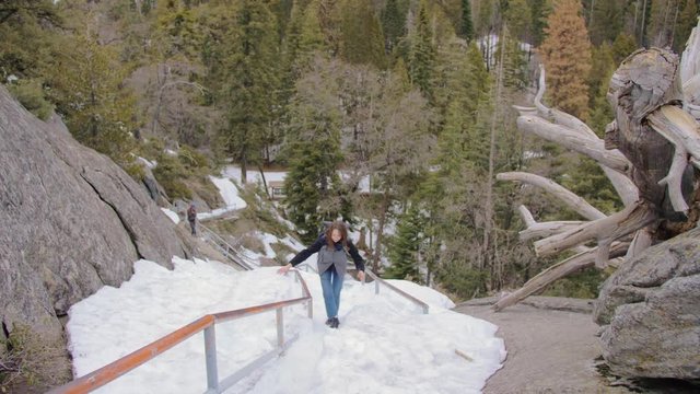 shot of traveler girl climbing the slippery road up to the moro rock mountain