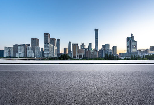 empty raod with city skyline