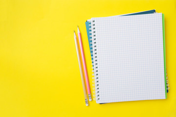 Clean white notebook and pencil with copy space on yellow table background for presentation, writer...