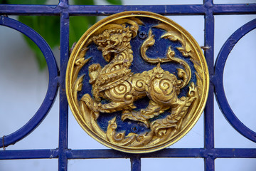 Medallion seen on fence from street walking around Bangkok, Thailand