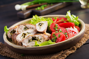 Delicious chicken rolls stuffed with cheese and spinach wrapped in strips of bacon.