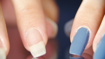 Long fingernails comparison between nude and blue