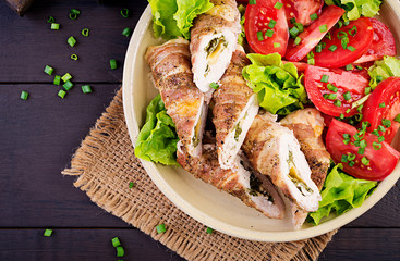 Delicious chicken rolls stuffed with cheese and spinach wrapped in strips of bacon. Top view