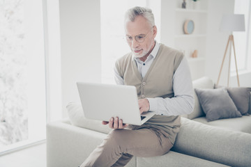 Close up photo amazing intelligent he him his aged man hands arms notebook search look information writing keyboard wear white shirt waistcoat pants sit cozy divan flat house living room indoors