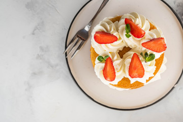 Strawberry cake with vanilla cream on white background. Copy space.