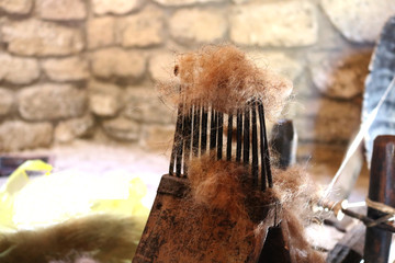 Antique spinning wheel and wool comb