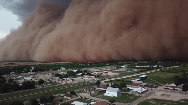 dust storm coming to the city ,shot taken by a drone