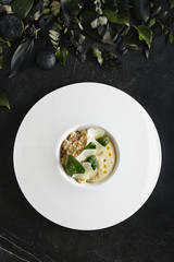 White Restaurant Plate of Risotto with Cep Mushroom Stew, Parmesan Cheese and Greens Top View