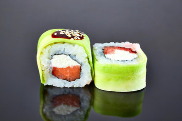 Philadelphia roll sushi with salmon, avocado, and cream cheese on black background for menu. Japanese food