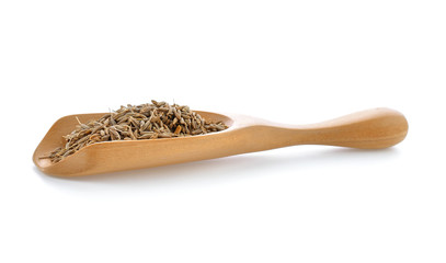 caraway seeds in wood scoop on white background