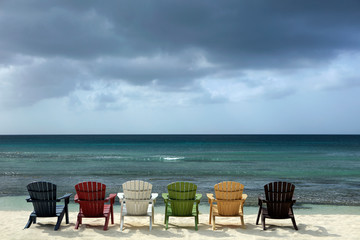 Colorful Wooden Chairs on Beautiful Palm Beach of Aruba Island , Netherlands Antilles