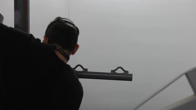 Professional air brusher working in a factory on metal parts 3