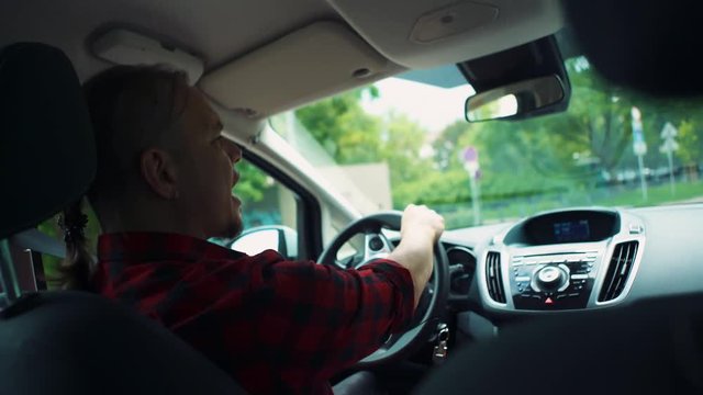 Crazy guy rash driving and enjoying music, handheld shot