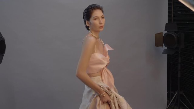 Beautiful high fashion model woman dances in photo shoot outtakes