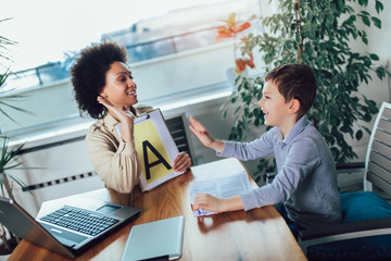 Shot of a speech therapist during a session with a little boy