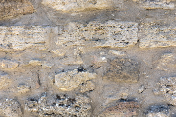 Background of ancient brick wall. Texture of old stone for design.