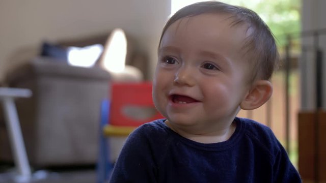 Closeup shot of a cute baby boy smiling and laughing