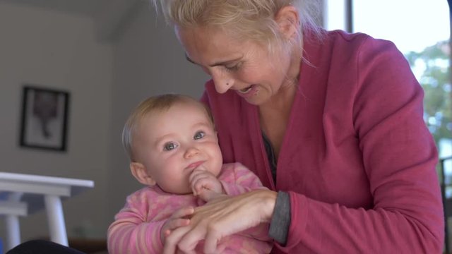 Closeup shot of a woman playing with her baby daughter