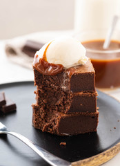 Chocolate brownies with salted caramel, vanilla ice cream. Copy space.