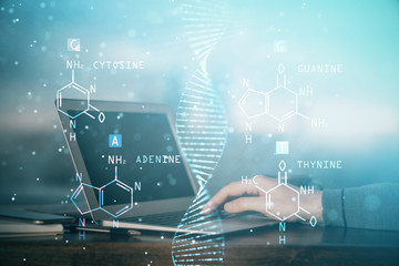 DNA hologram with businessman working on computer on background. Concept of bioengineering. Double exposure.