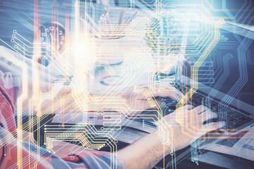 Double exposure of world map hologram with man working on computer on background. Concept of worldwideweb.