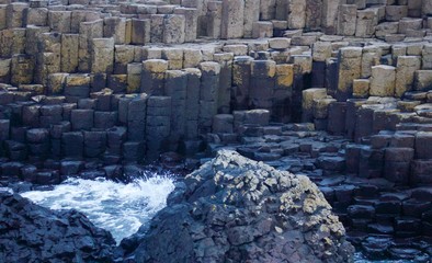 View of the Rocks of Giants Causeway with sea sprayed rocks and Ocean