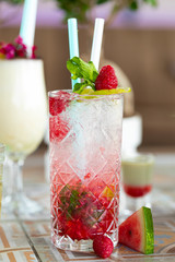 Raspberry Mojito Lemonade with lime and fresh mint in glass