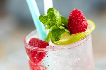 Raspberry Mojito Lemonade with lime and fresh mint in glass