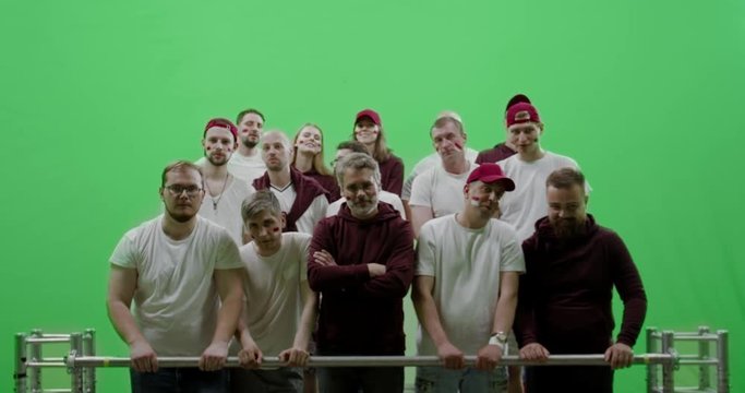 GREEN SCREEN CHROMA KEY Front view group of people fans wearing red clothes watching a sport event. 4K UHD ProRes 422 HQ