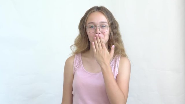 close-up of a teenager girl in a pink vest funny and incendiary dancing on a white background