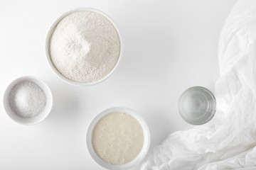 Ingredients for baking unleavened bread on a white table in a white bowl