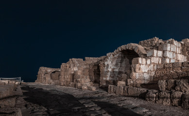 Fototapeta premium Night view of the ruins of Caesarea city on the Mediterranean coast, which was built by the king of Judea, Herod the Great, in honor of the Roman emperor Caesar Augustus