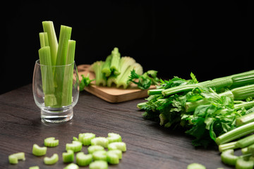 Bunch of fresh celery stalk on wooden table with leaves prepared for making juice. Food and ingredients  of healthy vegetable. Freshness herbal and low calories for dieting with plenty of vitamin