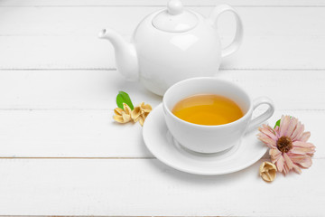 teapot and cups of tea on a white wooden background