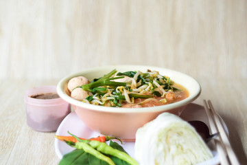 noodle soup with chopsticks in bowl on a wooden table,Thailand style