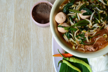 noodle soup with chopsticks in bowl on a wooden table,Thailand style