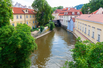 Fototapeta na wymiar Certovka Canal running through local neighbourhood of Prague, Czech Republic