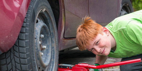 young teenager doing internship in a car workshop