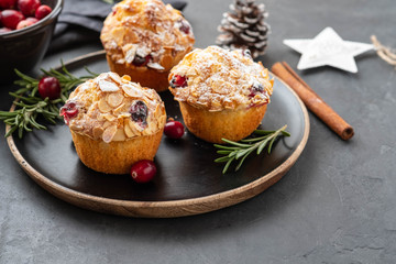 Muffins, cakes with cranberry, rosemary and almond nuts. Christmas decoration. Copy space.