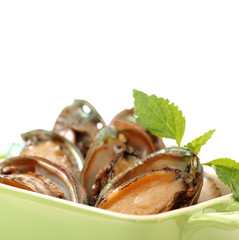 Raw abalones on the white background 