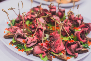 Beautifully decorated catering banquet table with different food snacks and appetizers on corporate, christmas, birthday party event or wedding celebration