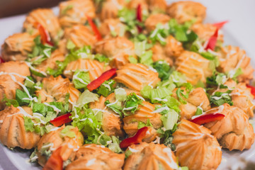 Beautifully decorated catering banquet table with different food snacks and appetizers on corporate, christmas, birthday party event or wedding celebration