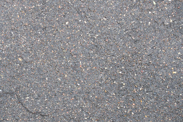 wet gray asphalt with stones background