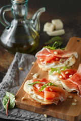 Traditional parma cured ham antipasto. Bruschetta set with Parma Ham and Parmesan Cheese. Small...
