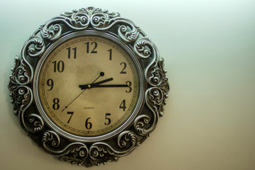 Ancient Wall Designer Wall Clock With Light Yellow Back Ground showing time 02:15 o'clock